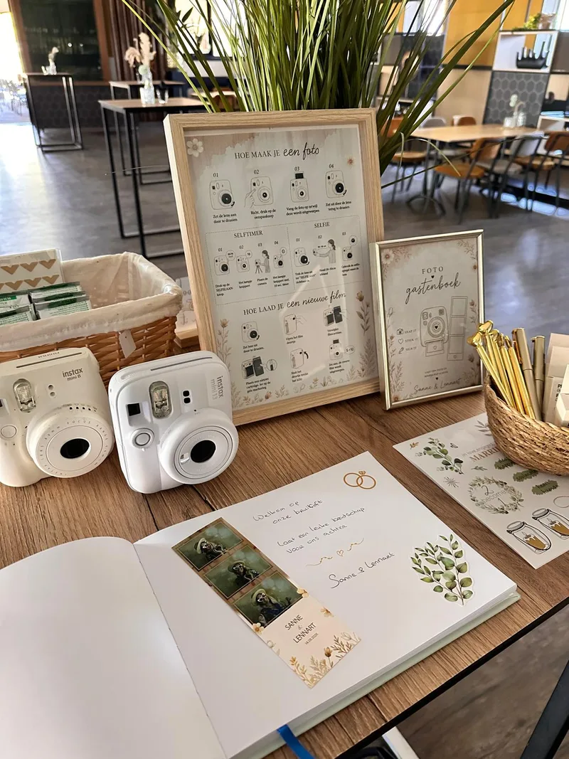 Instax-tafel met twee camera’s, uitlegbord en gastenboek met fotostrip